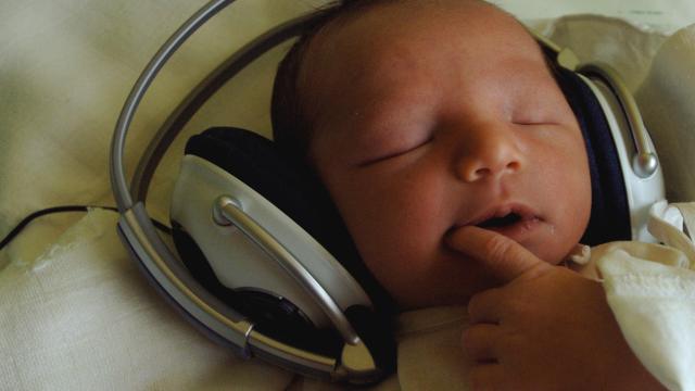 One-day-old newborn baby Timea listens