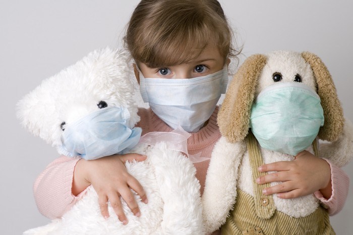 bigstock-Little-girl-with-toys-wearing-16362665-e1407471051361